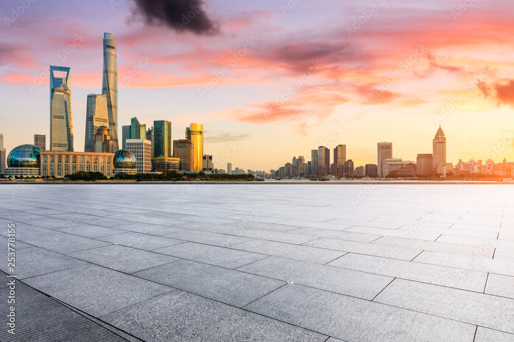 Empty square floor and modern city buildings in Shanghai at dusk