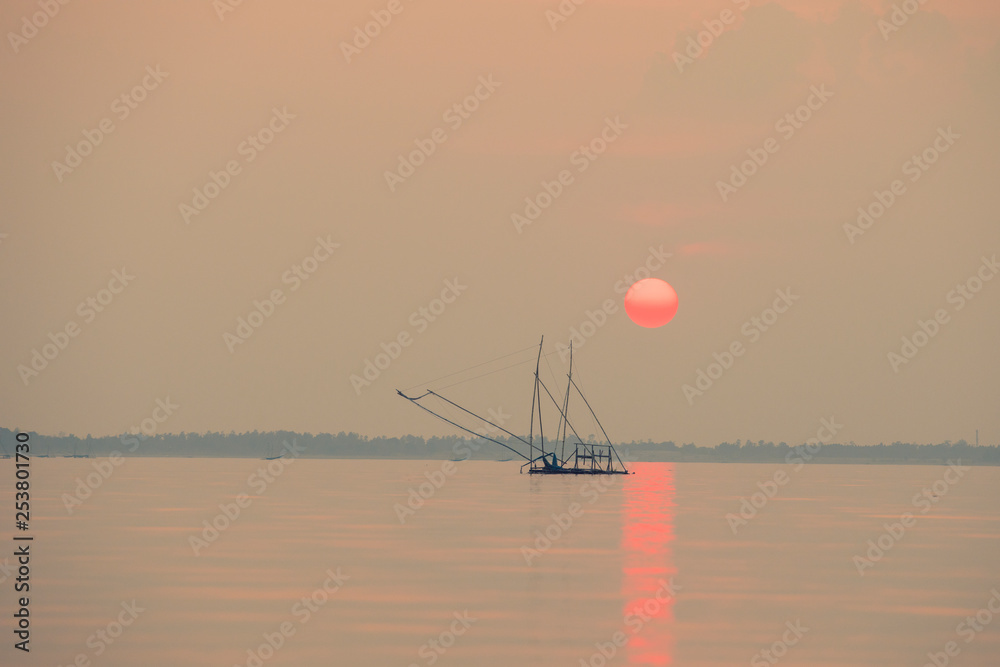 日出或日落与湖泊或河流，传统捕鱼，美丽的日落背景