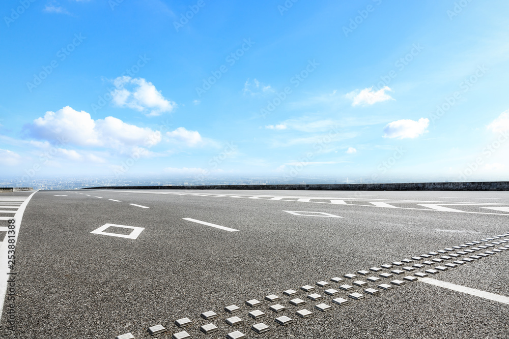 Asphalt highway passing above modern city