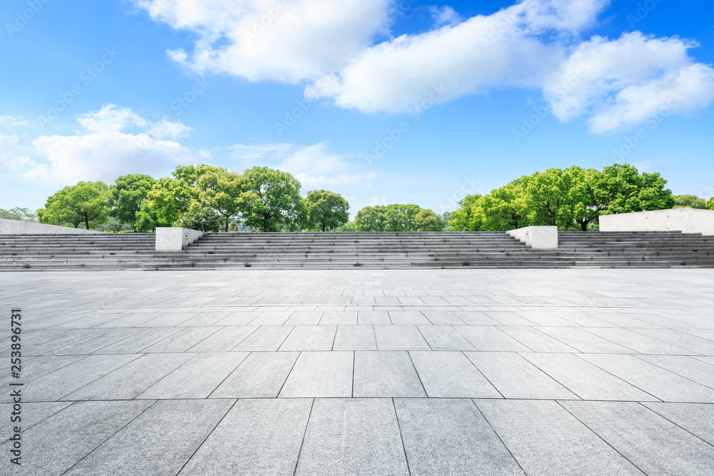 Empty square floor and green forest in the city park