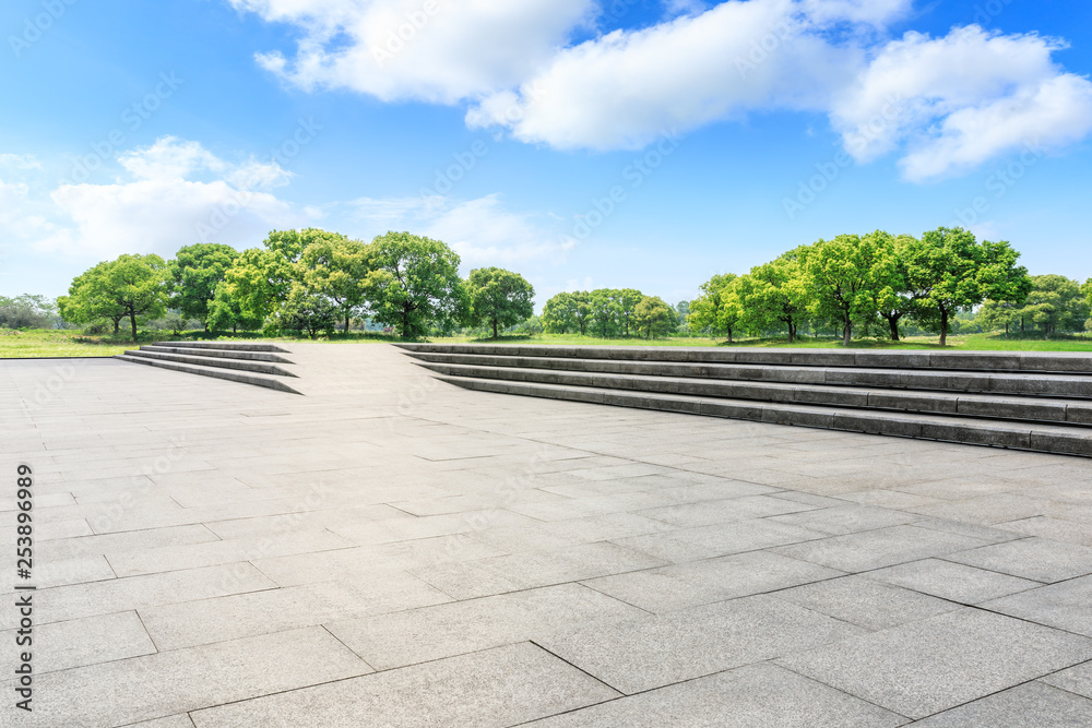 Empty square floor and green forest in the city park