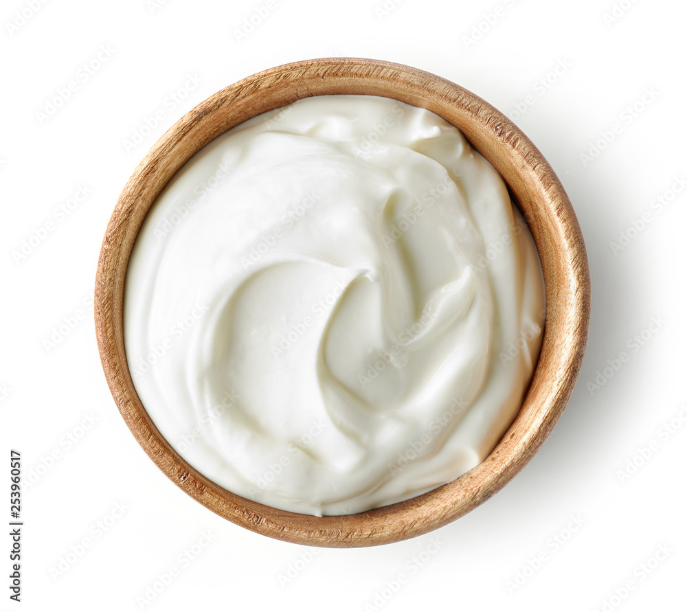 sour cream or yogurt in wooden bowl