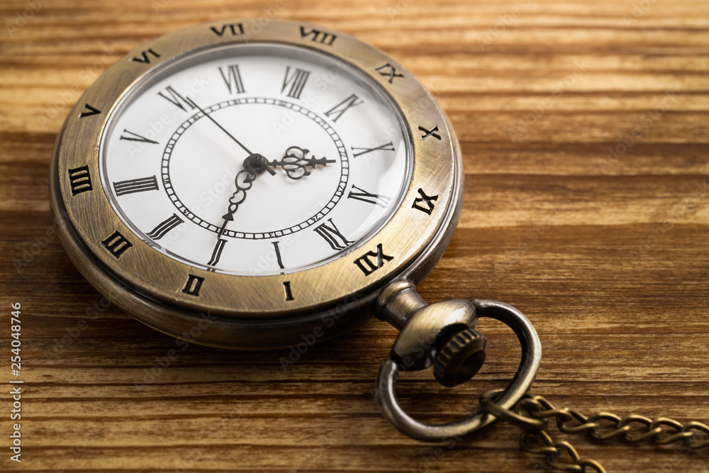 Vintage pocket watch clock on wooden background