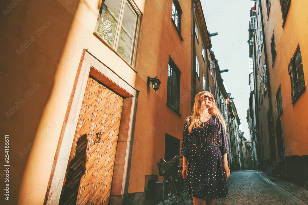 Young woman walking in Stockholm city excursion traveling in Sweden lifestyle summer Europe vacation