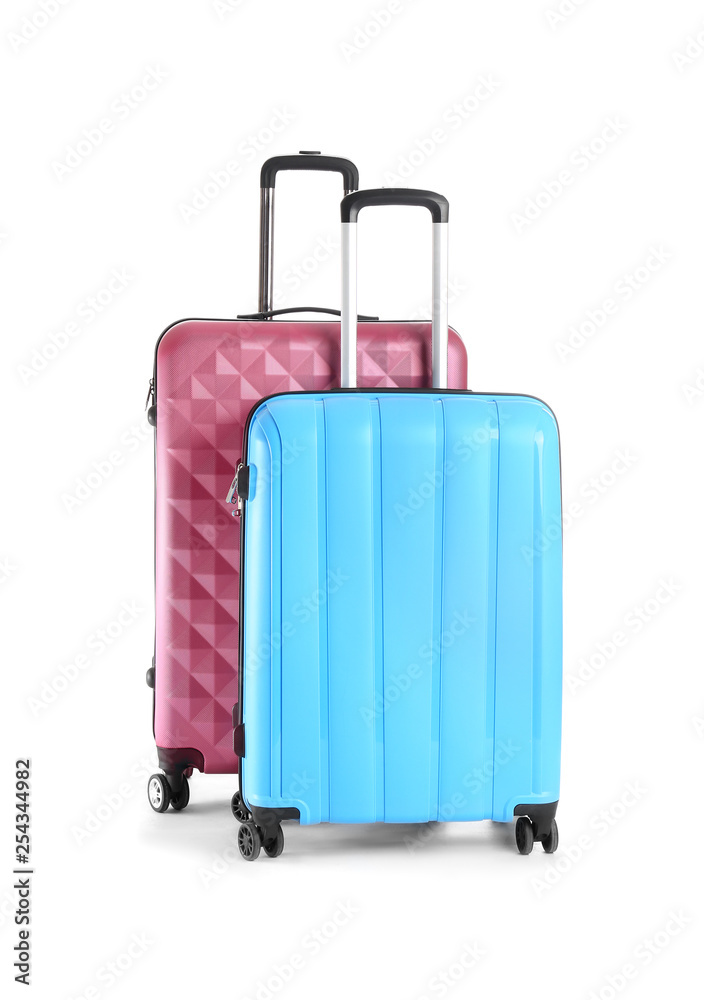 Packed suitcases on white background