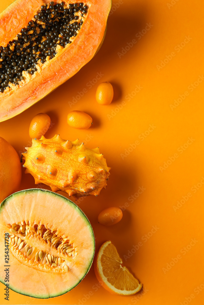 Assortment of tasty exotic fruits on color background