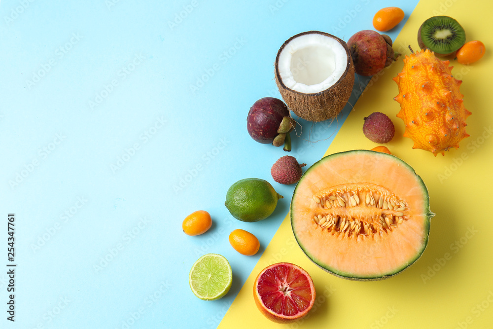 Assortment of tasty exotic fruits on color background