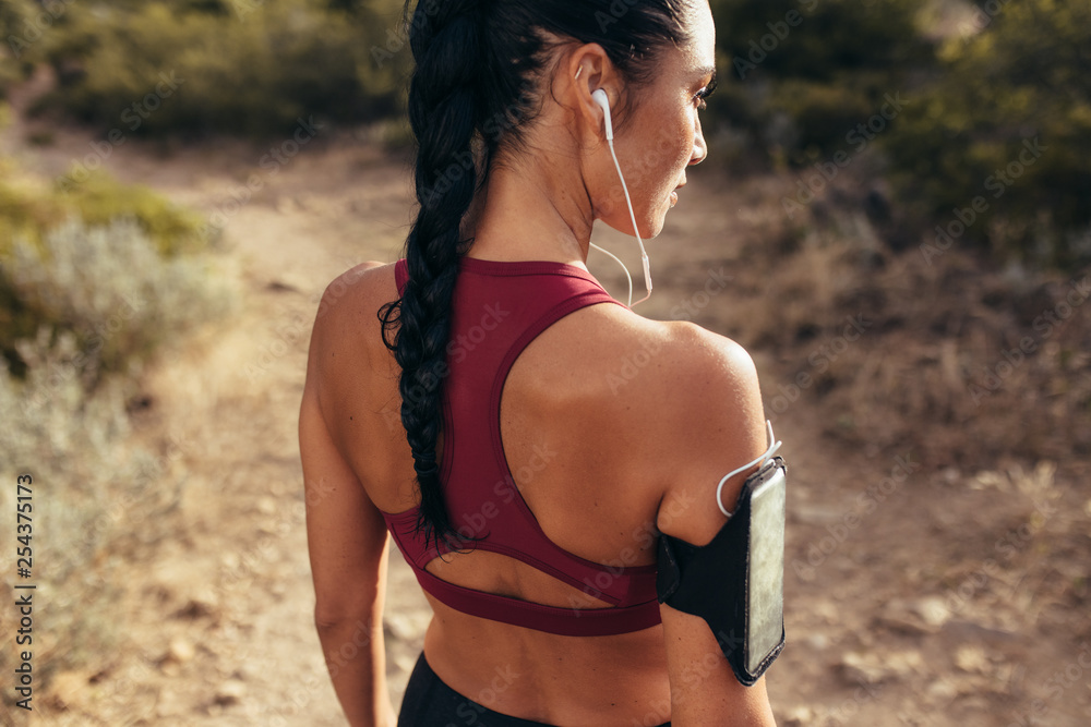 Female athlete before her run on mountain trail