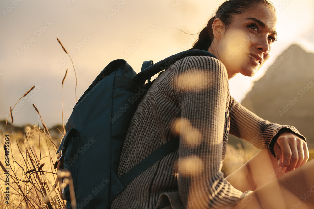 Woman sitting relaxed after her hike.