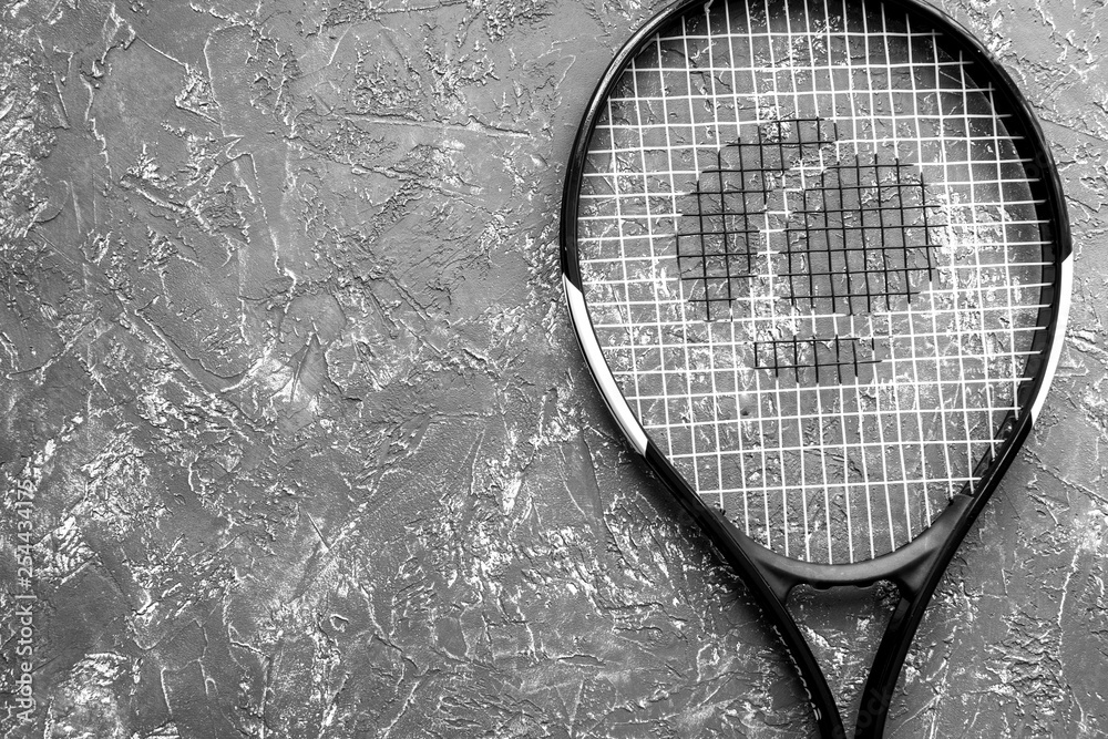 tennis racket on gray background top view