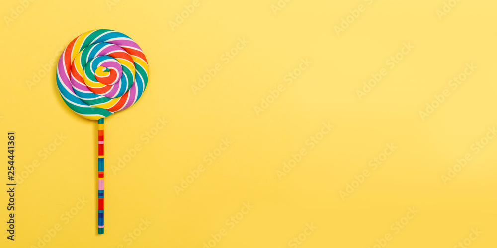 Big lollipop on a yellow paper background