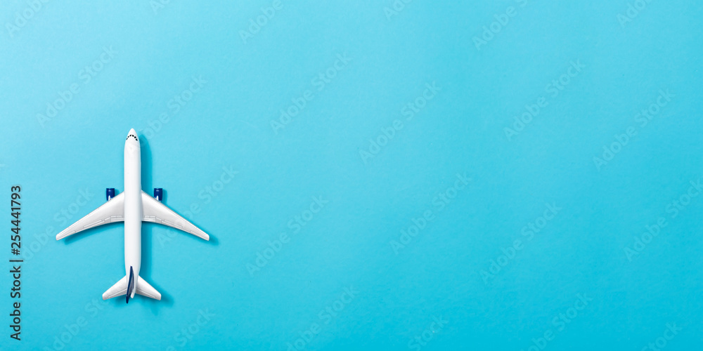 A toy airplane on a blue paper background