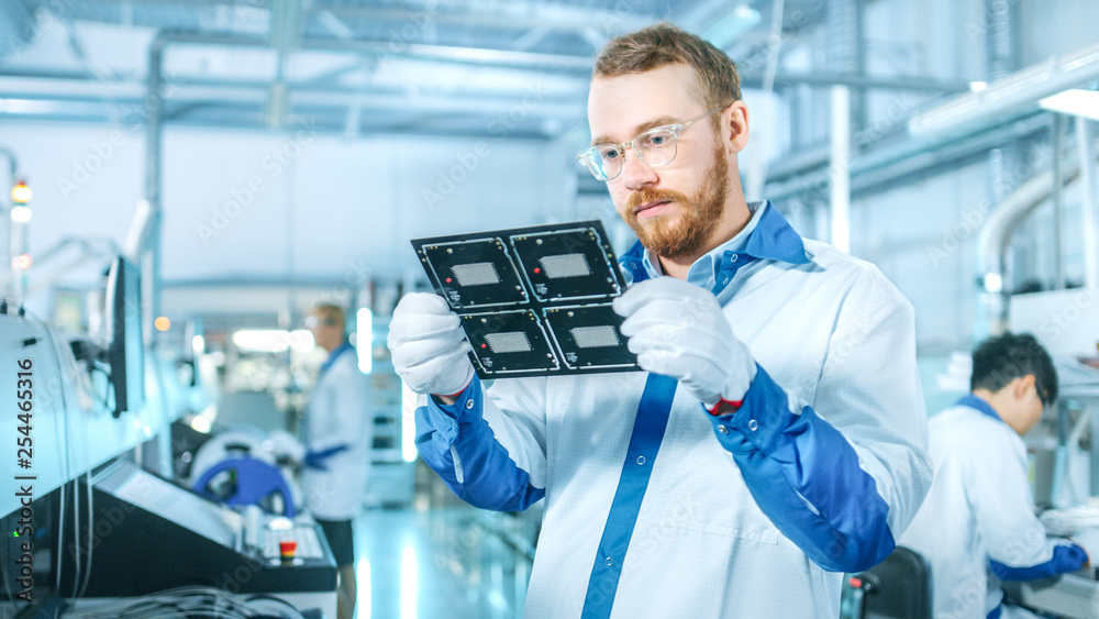 High-Tech Factory: Quality Control Inspector Checks Electronic Printed Circuit Board it for Damages.