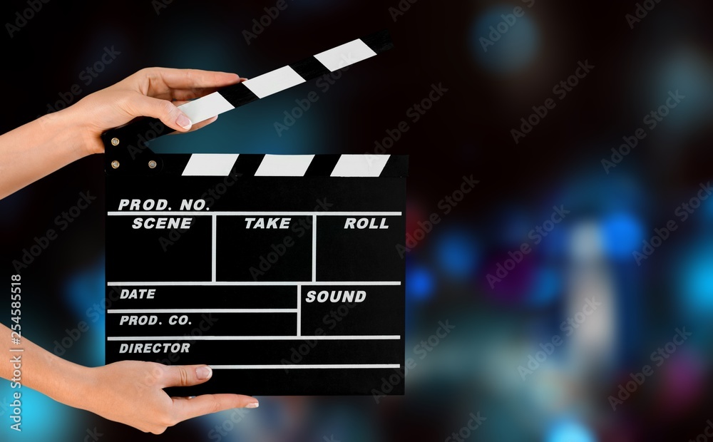 Cinema clapperboard in female hands