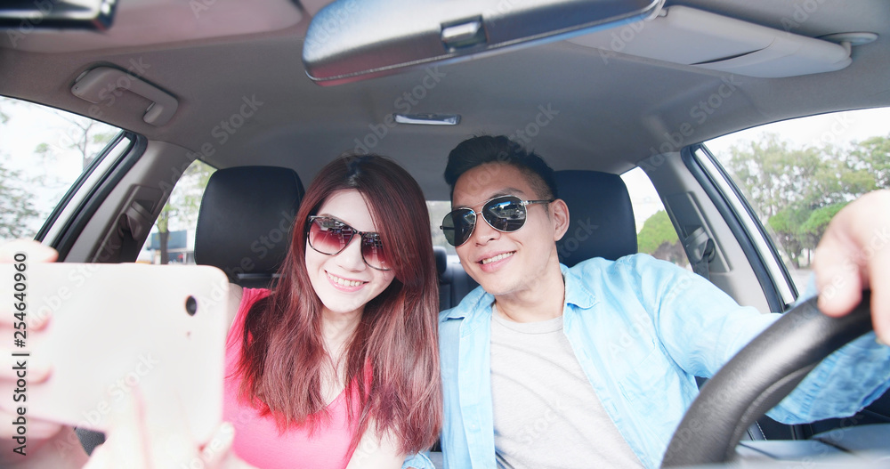 couple take selfie in car