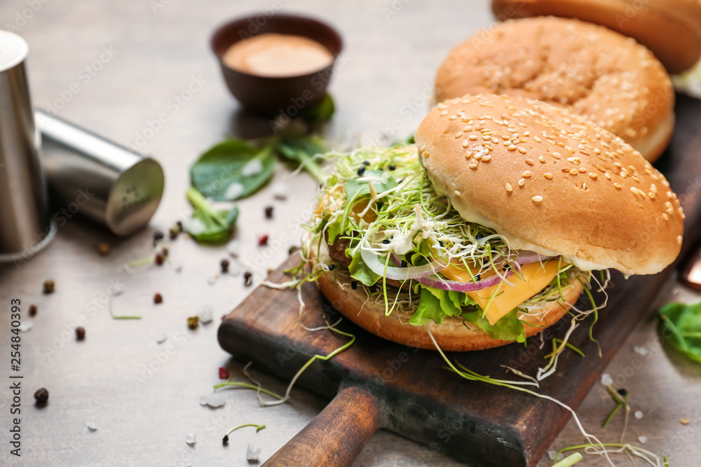 Tasty burgers on table