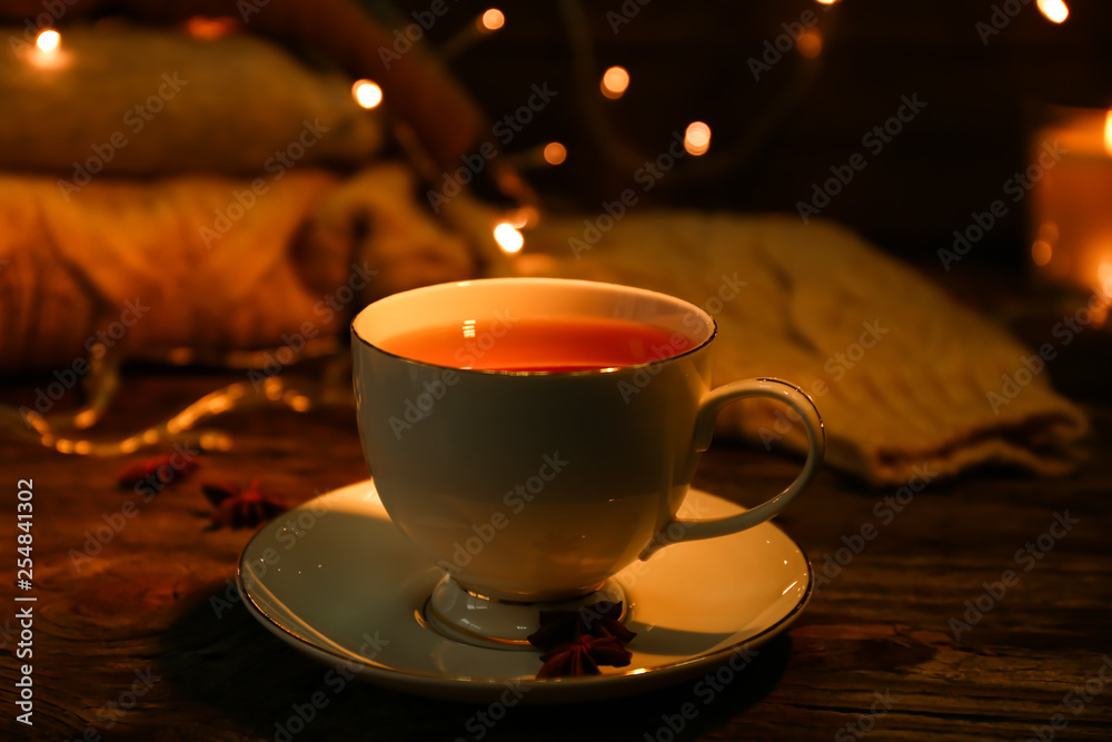 Cup of hot tea on wooden table