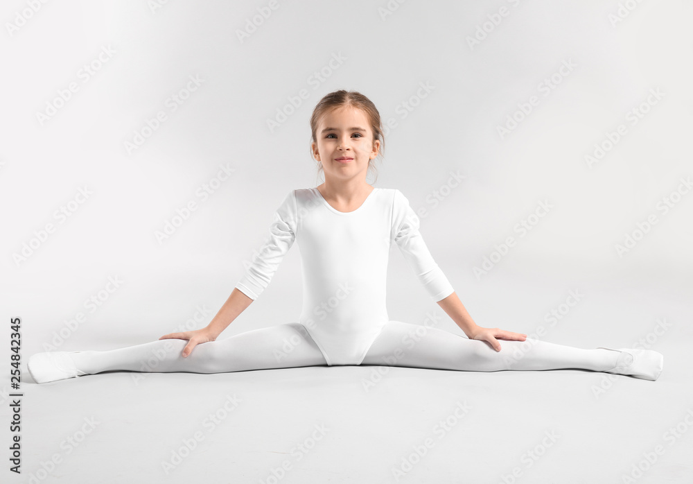 Cute little ballerina on light background