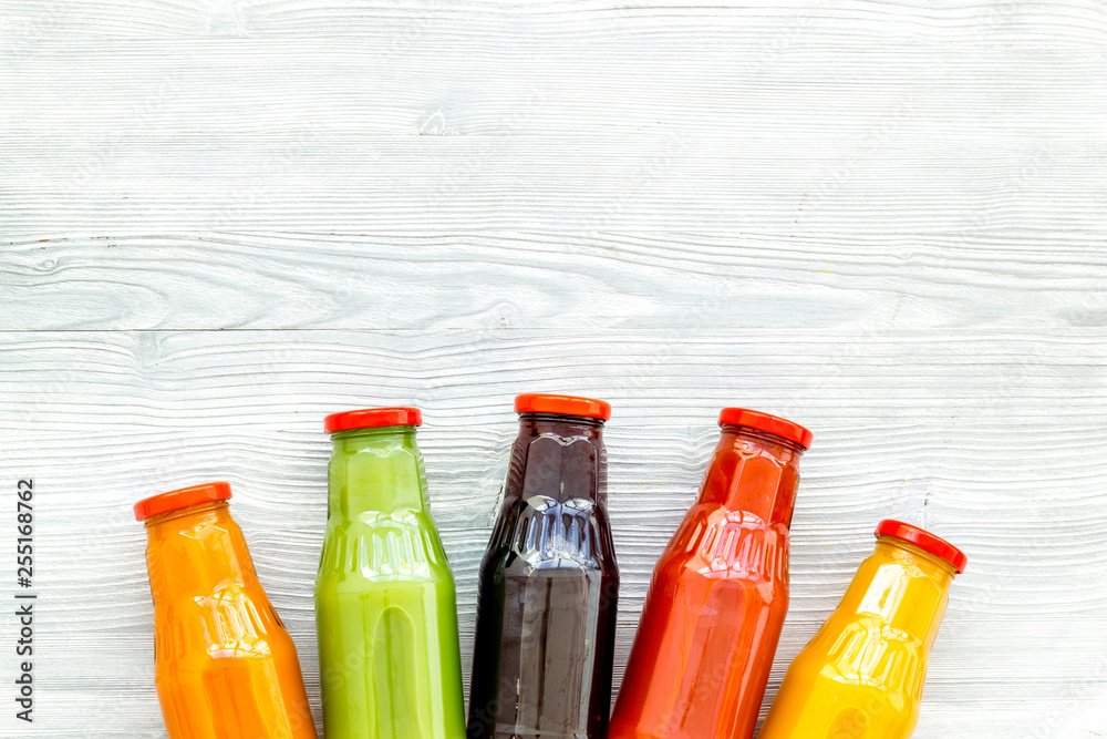 fresh organic juices in bottles for fitness diet on white background top view mock-up