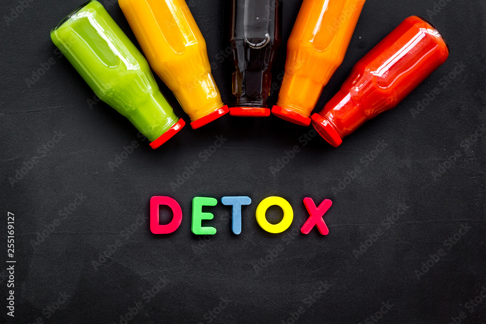 healthy organic juice in bottles for fitness diet and detox on black background top view mockup