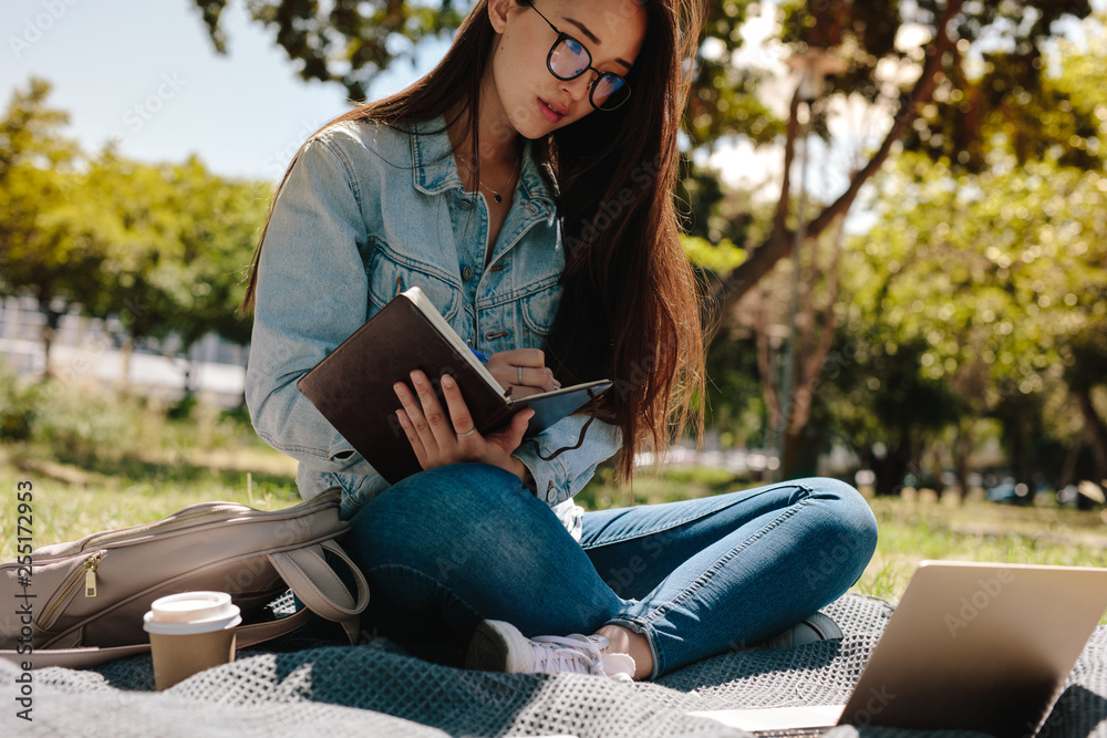 Student sitting in college campus and studying