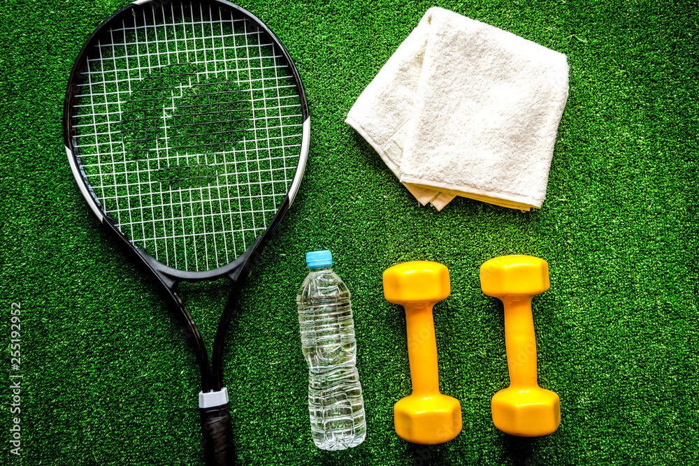 tennis racket on green background top view