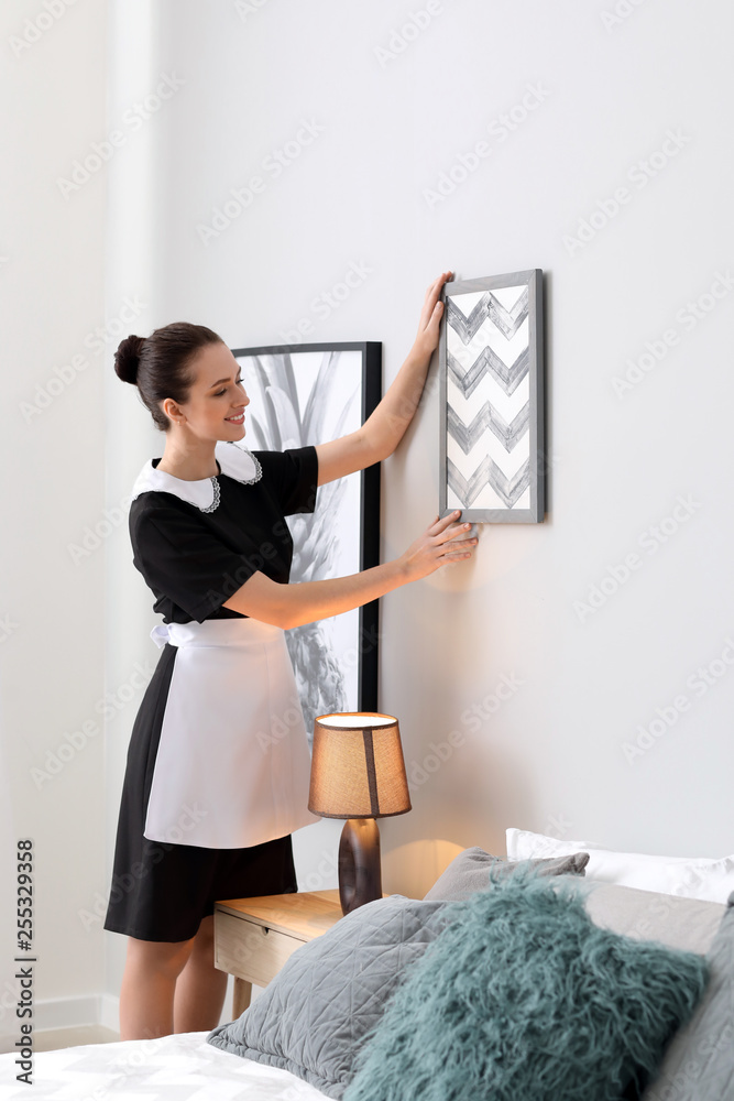 Beautiful female housekeeper in room