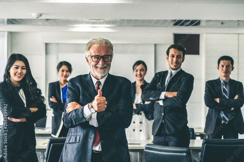 Senior executive CEO manager standing in front of team members Business leadership concept.