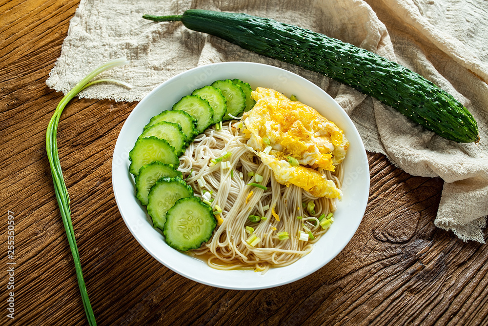 a bowl of cucumber egg noodles