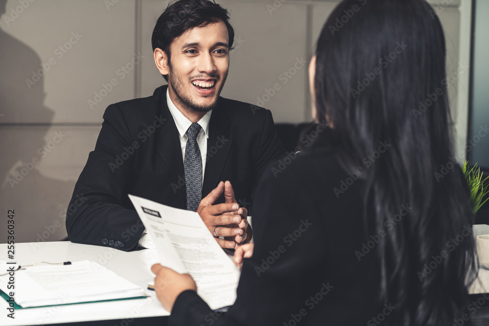 Human resource manager interviewing the male employment candidate in the office room. Happy job inte