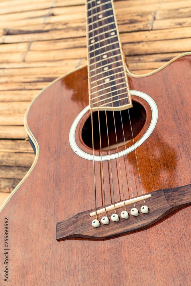 Classical guitar on wood background. Music and entertainment concept.