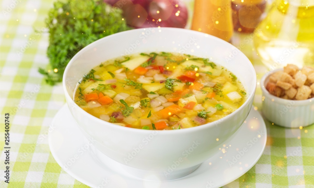 Chicken vegetable soup on desk