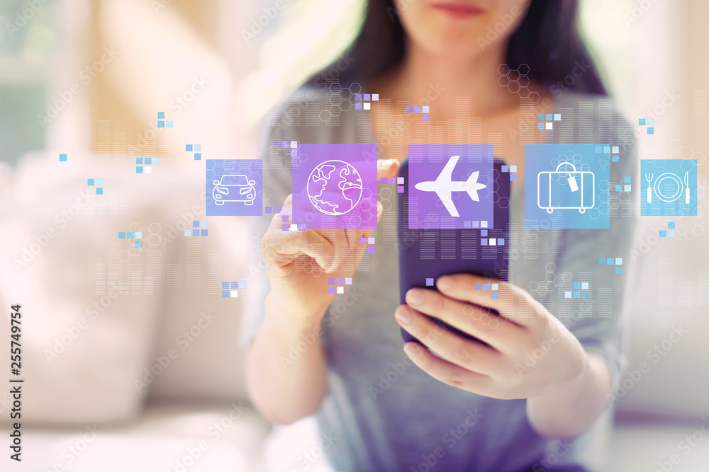 Airplane travel theme with woman using her smartphone in a living room