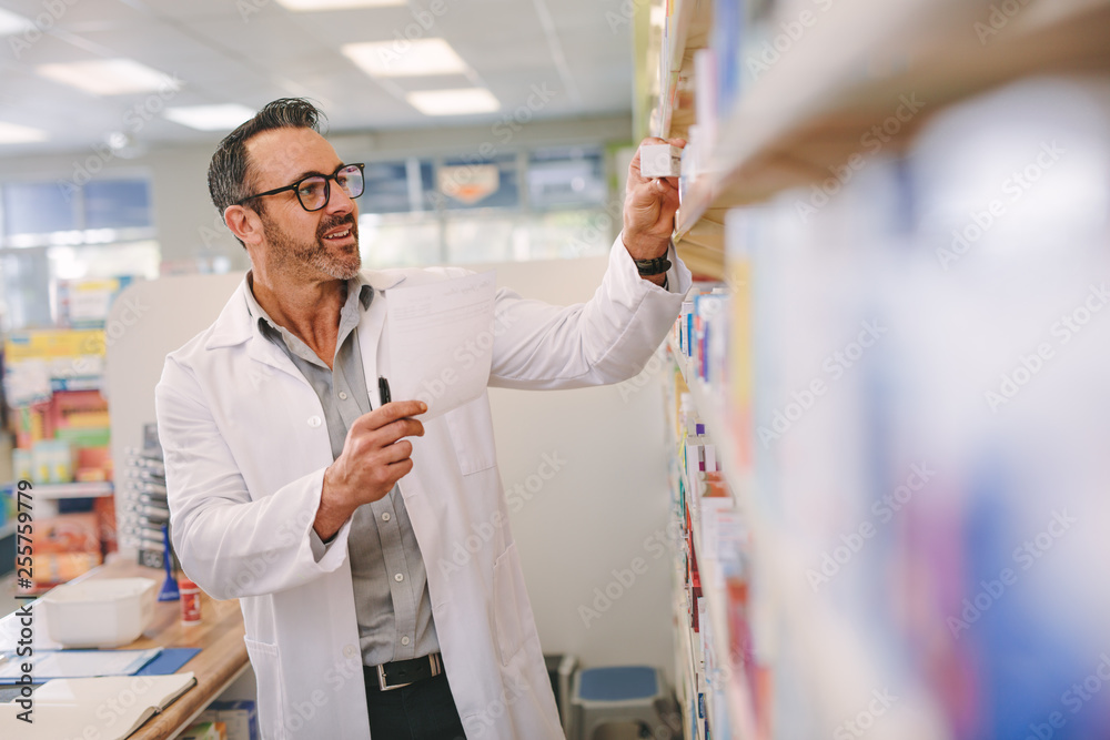 Pharmacist looking for medicine in the store