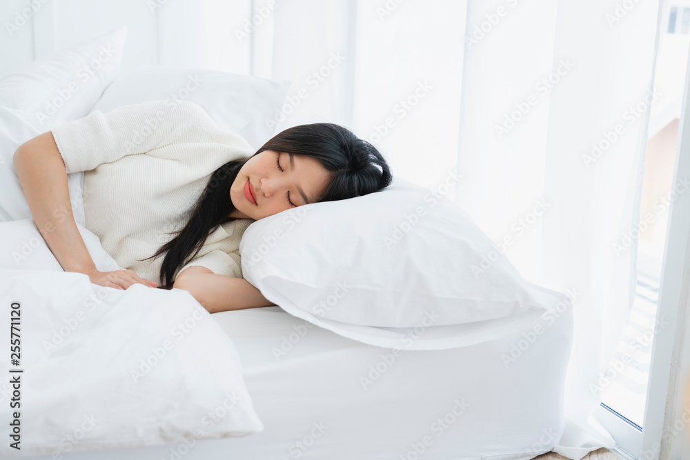 beautiful attractive asian woman white dress sleep on white duvet bed pillow home background morning