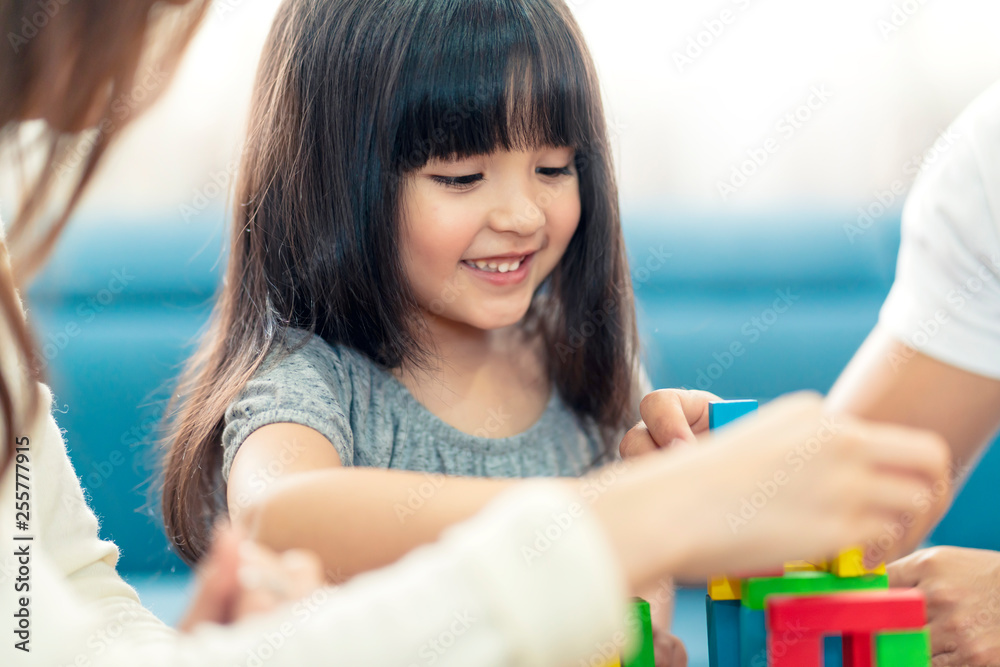 happy family caucasian and asian mixed race with pretty daughter enjoy family time with toy  togethe