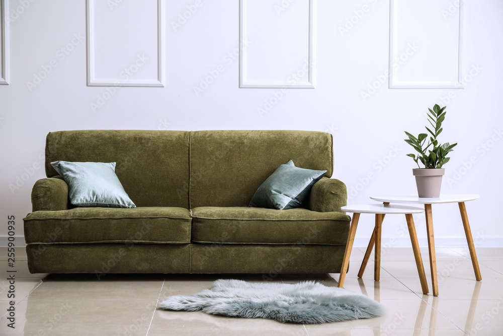 Comfortable sofa with table in interior of room