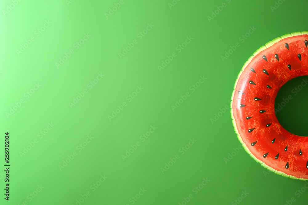 Bright inflatable ring on color background