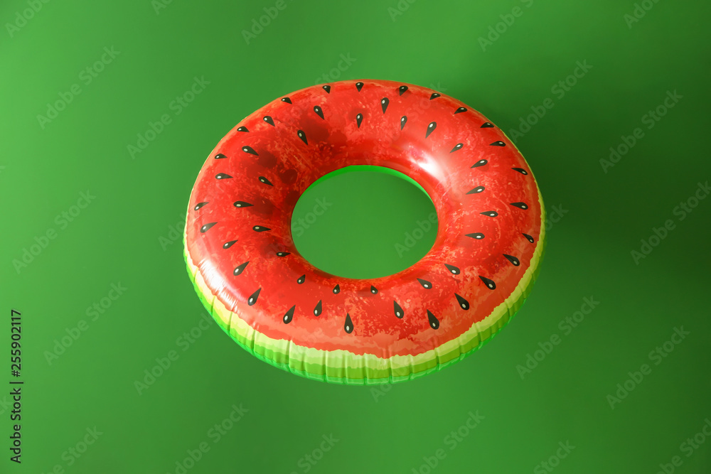 Bright inflatable ring on color background