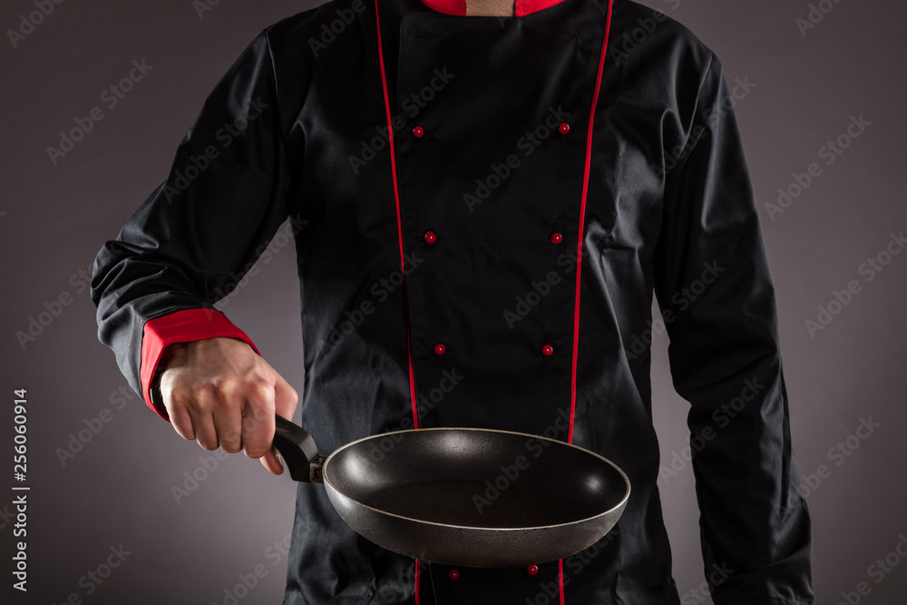 Closeup of master chef holding empty frying pan