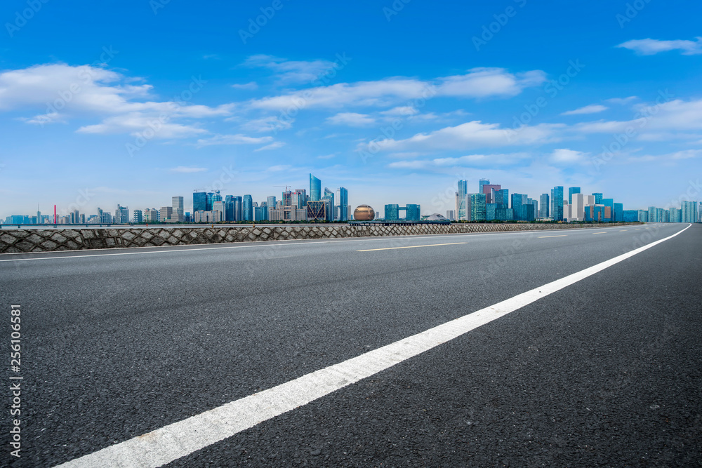 Foreground highway asphalt pavement city building commercial building office building