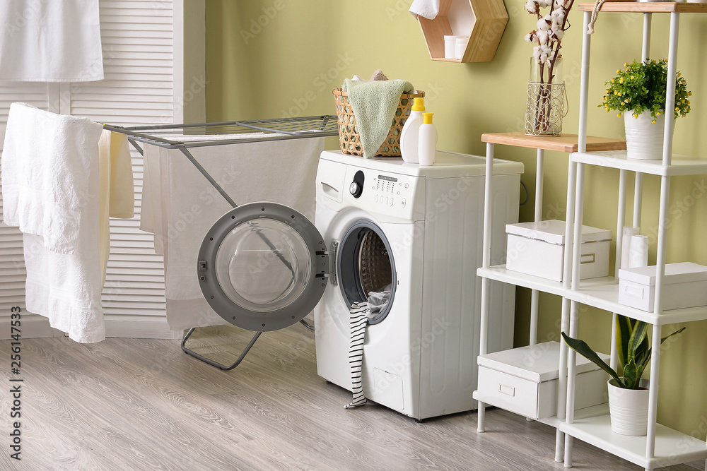 Interior of home laundry room with modern washing machine