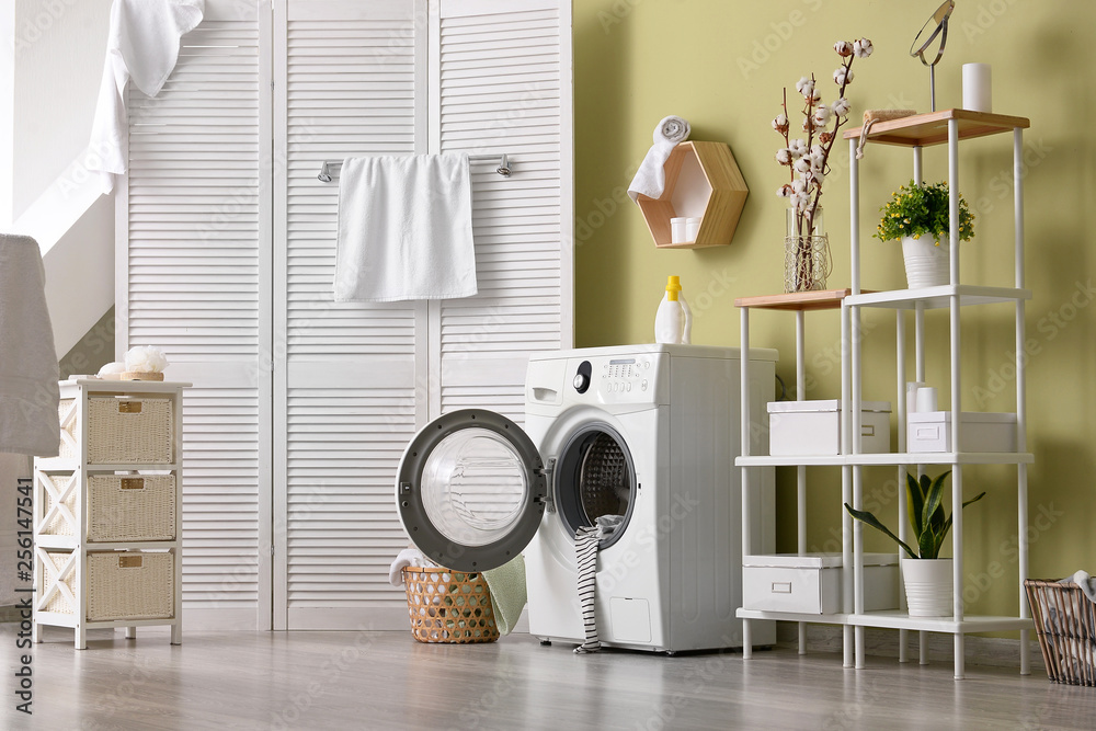 Interior of home laundry room with modern washing machine