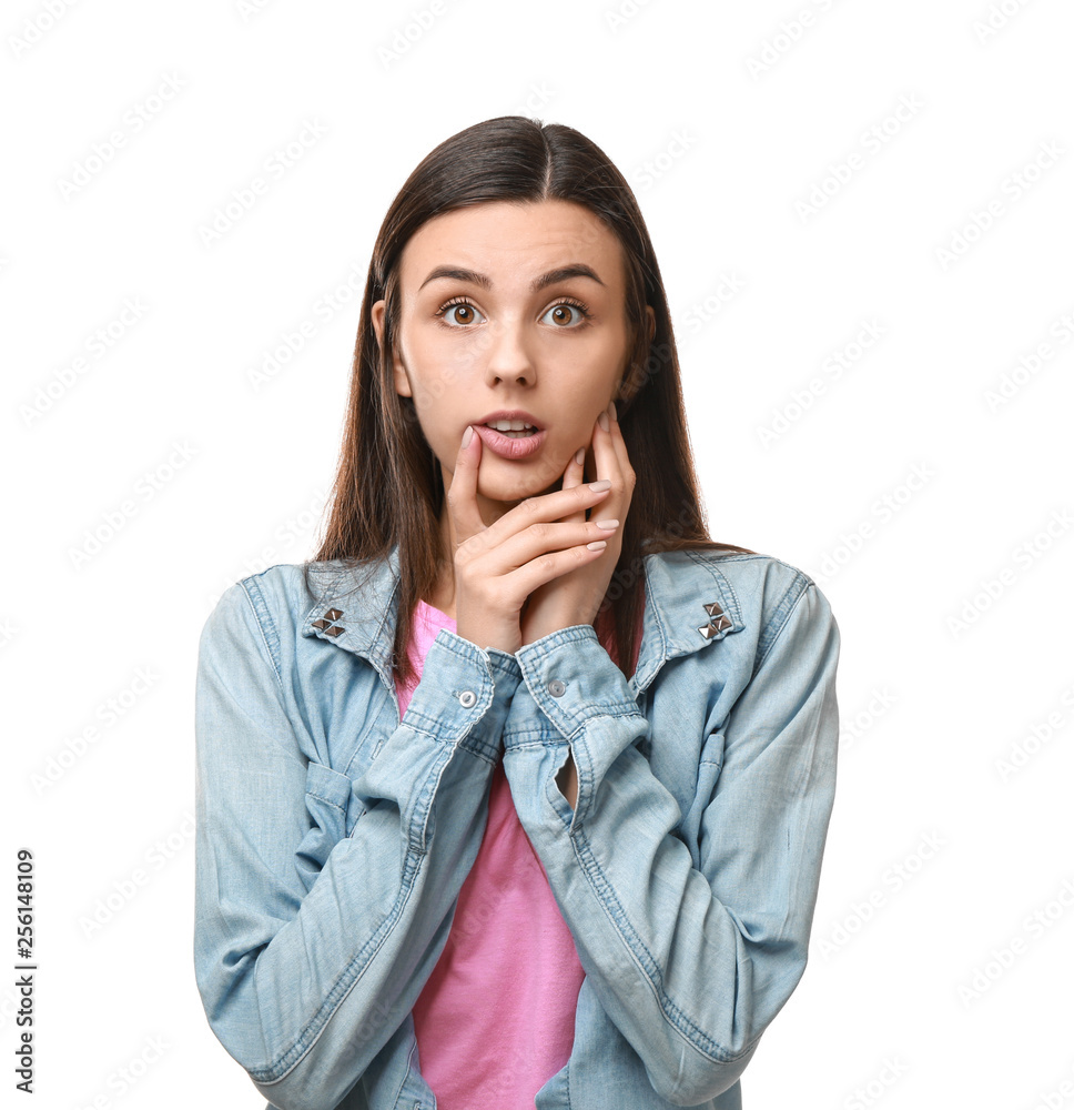 Portrait of beautiful shocked young woman on white background