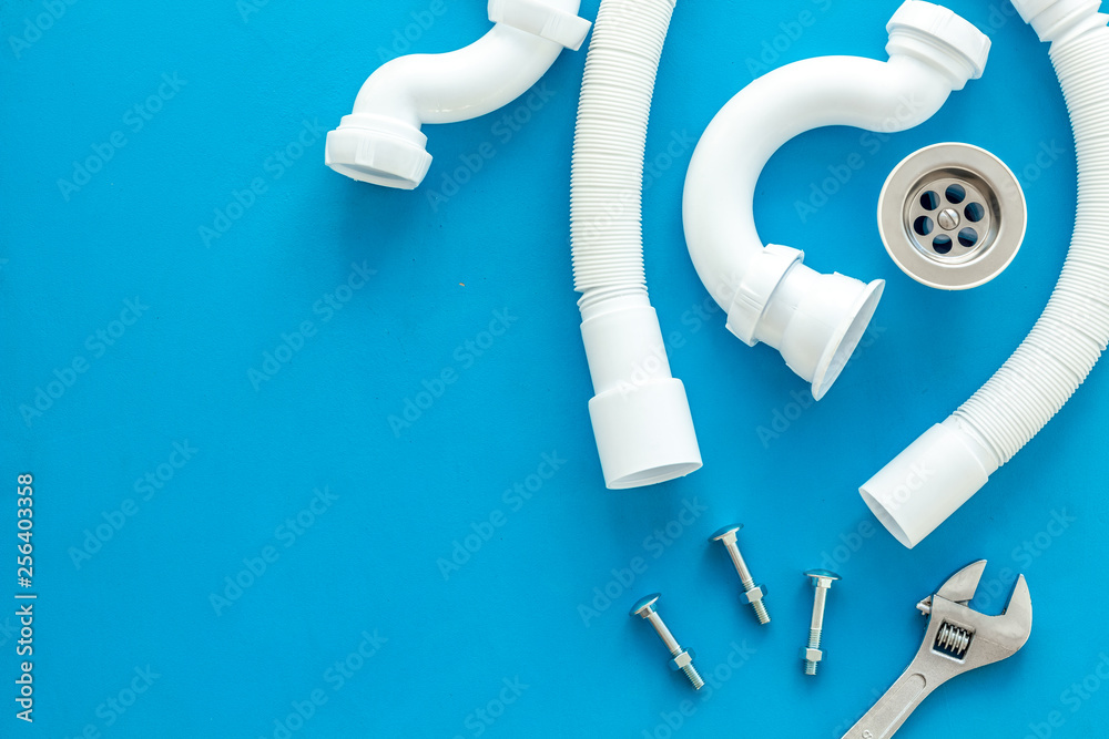 Professional instruments for plumber on blue background top view space for text