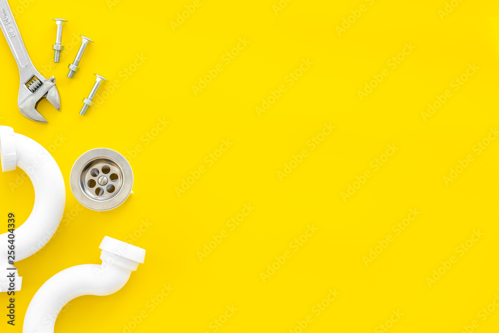 Professional instruments for plumber on yellow background top view space for text