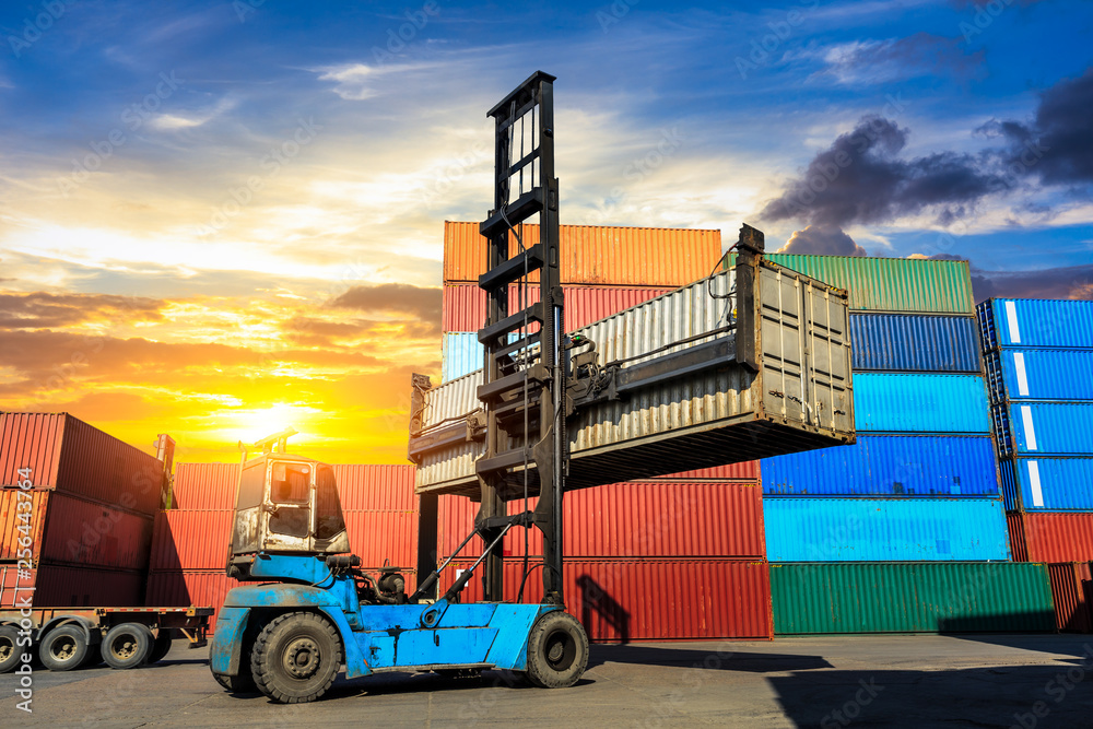 Forklift container loading and unloading cargo into the import-export zone