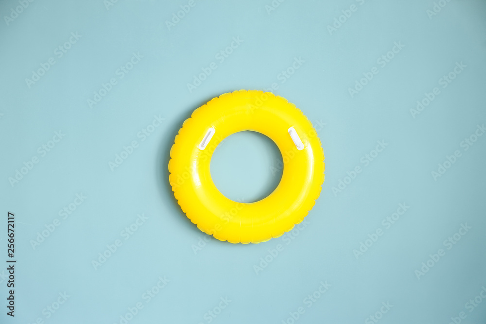 Bright inflatable ring on color background