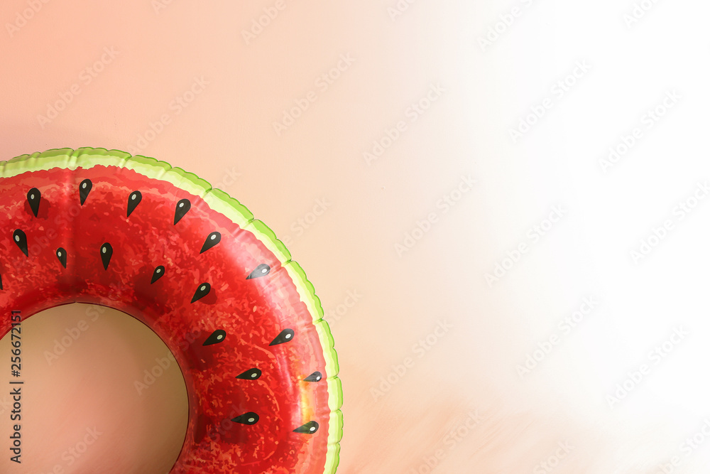 Bright inflatable ring on color background