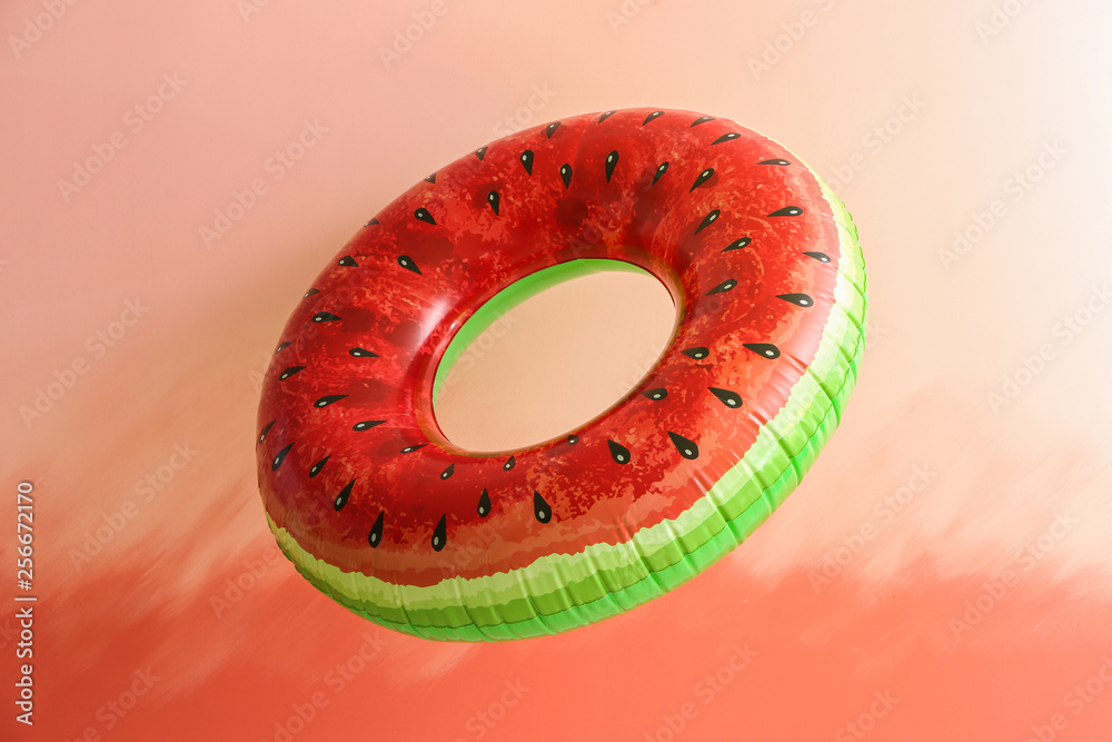 Bright inflatable ring on color background